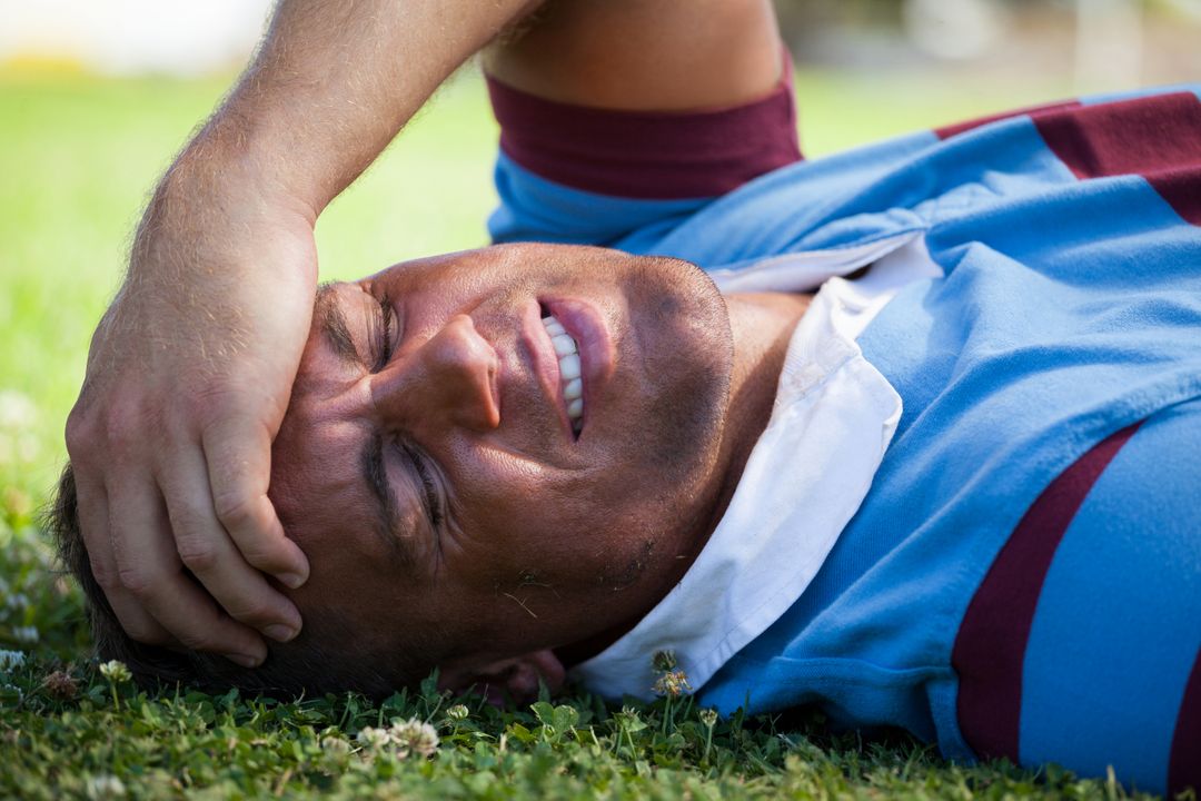 Injured Rugby Player Lying on Field in Pain - Free Images, Stock Photos and Pictures on Pikwizard.com