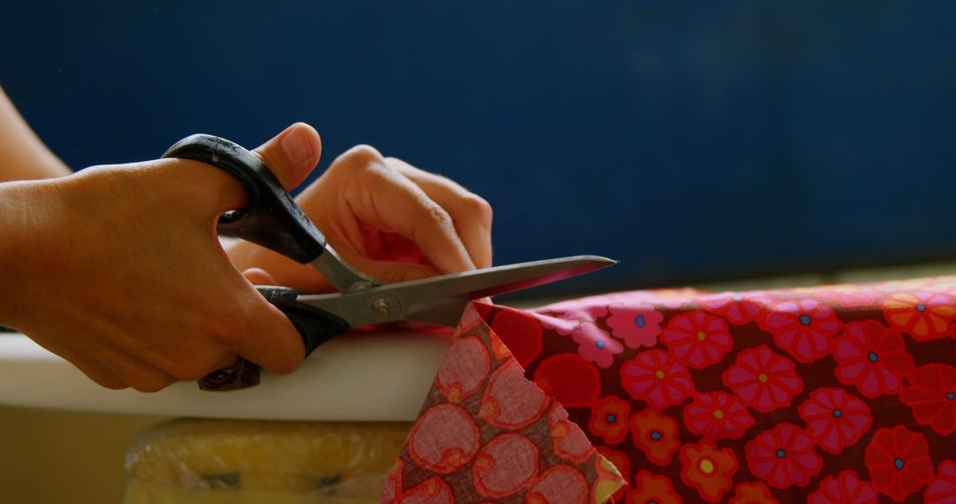 Close-Up of Hands Cutting Red Patterned Fabric - Free Images, Stock Photos and Pictures on Pikwizard.com