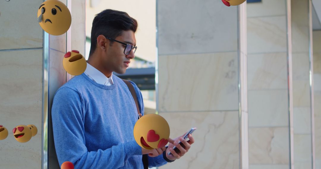 Young Man Texting on Smartphone with Floating Emojis