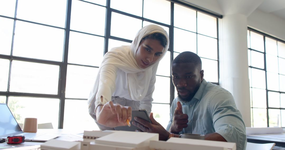 Diverse Business Team Collaborating on Innovative Project in Office