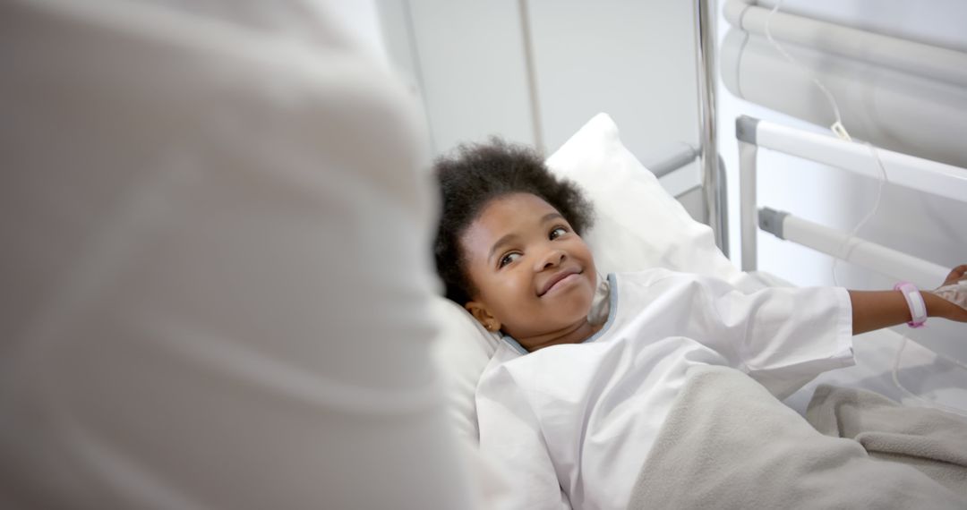 Smiling Child Patient Lying in Hospital Bed in Medical Ward - Free Images, Stock Photos and Pictures on Pikwizard.com