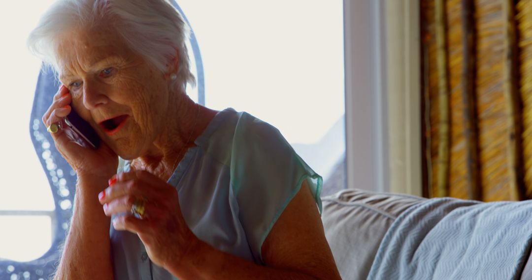 Elderly Woman Expressing Surprise While Talking on Phone - Free Images, Stock Photos and Pictures on Pikwizard.com