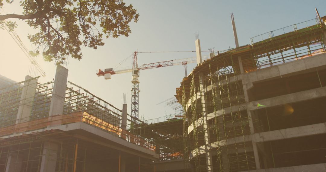 Urban Construction Site with Cranes and Scaffolding in Evening Light