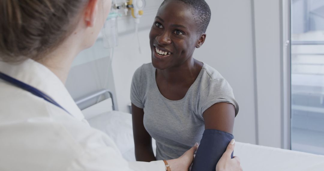 Female Doctor Checking Blood Pressure of Smiling Patient - Free Images, Stock Photos and Pictures on Pikwizard.com