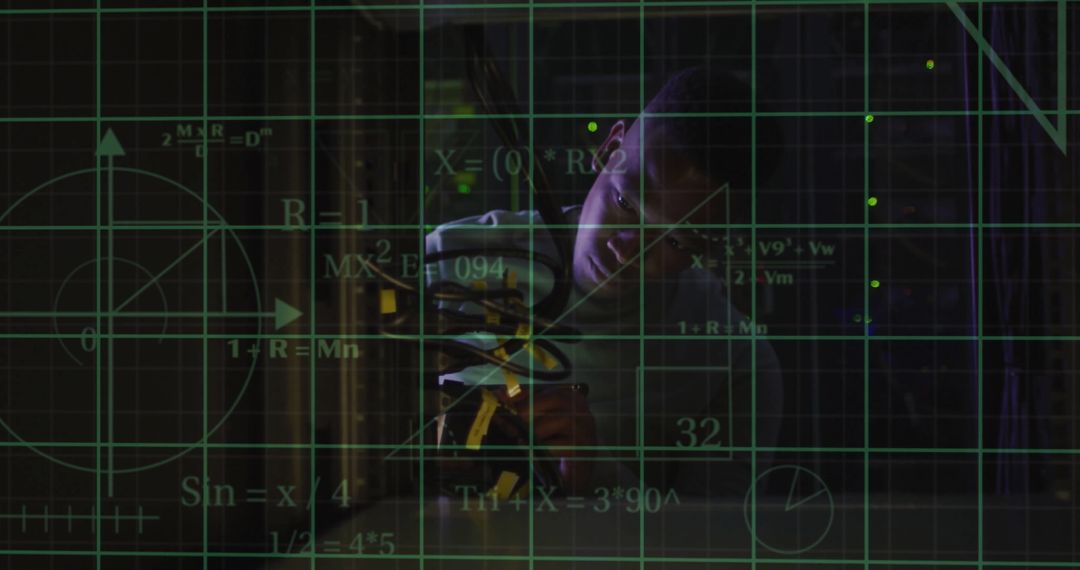 Young IT Technician Analyzing Data in a Server Room Environment