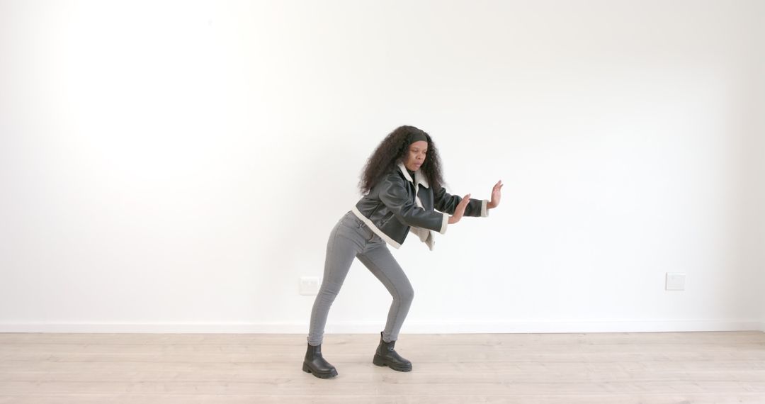 Energetic Young Woman Dancing Indoors on Wooden Floor