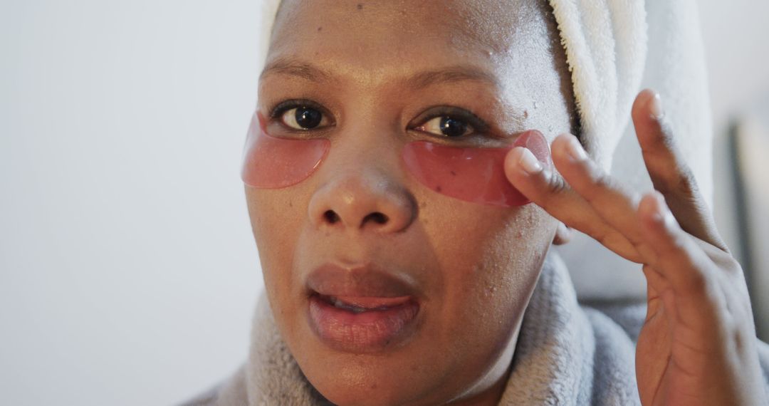 Woman Applies Skincare Under-Eye Patches in Bathroom Routine - Free Images, Stock Photos and Pictures on Pikwizard.com