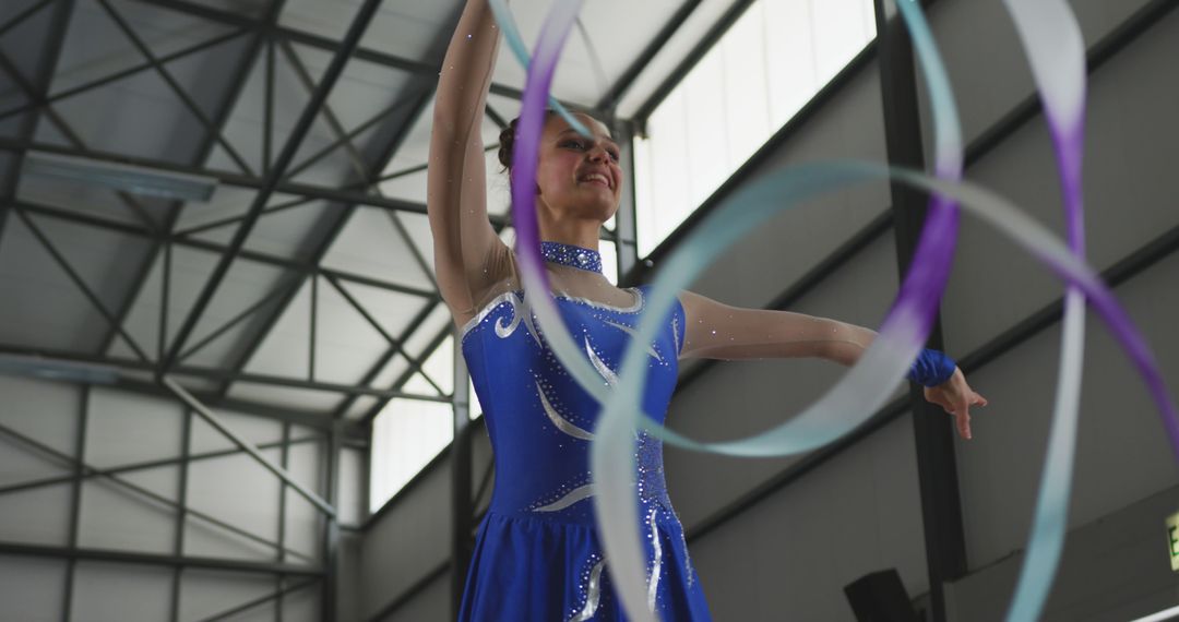 Rhythmic Gymnast in Blue Leotard Performing with Ribbons - Free Images, Stock Photos and Pictures on Pikwizard.com