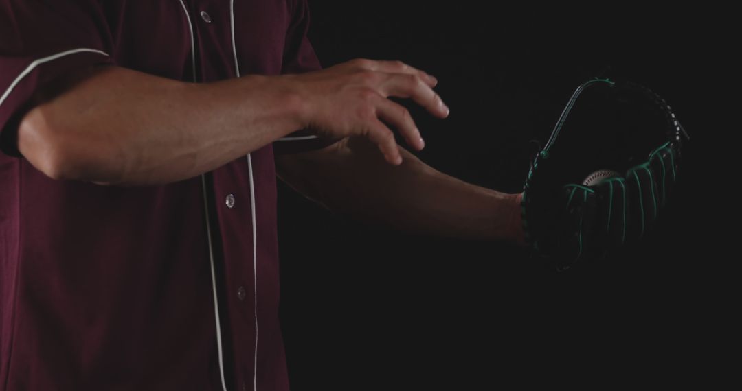 Baseball Pitcher Holding Glove Ready for Catch in Dark Background - Free Images, Stock Photos and Pictures on Pikwizard.com