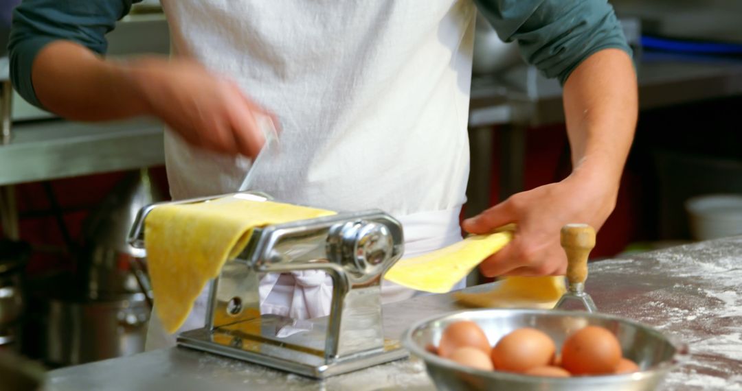 Chef rolling fresh pasta dough in professional kitchen - Free Images, Stock Photos and Pictures on Pikwizard.com