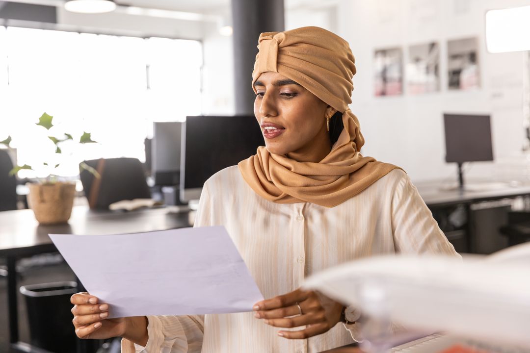 Professional Woman in Hijab Engaged in Office Task