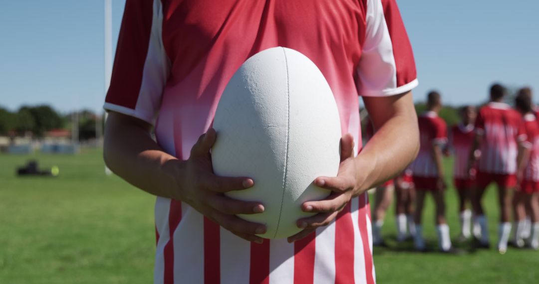 Rugby Player Holding Ball in Athletic Field Ready for Game - Free Images, Stock Photos and Pictures on Pikwizard.com