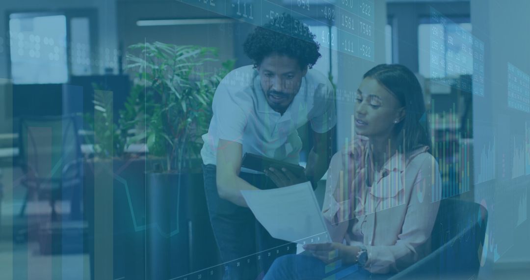 Business Colleagues Collaborating with Technology in Modern Office Lounge