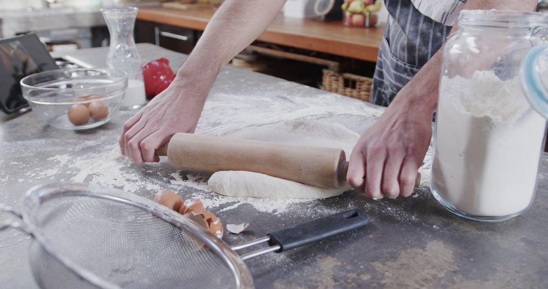 Baker Rolling Dough with Rolling Pin in Kitchen - Free Images, Stock Photos and Pictures on Pikwizard.com