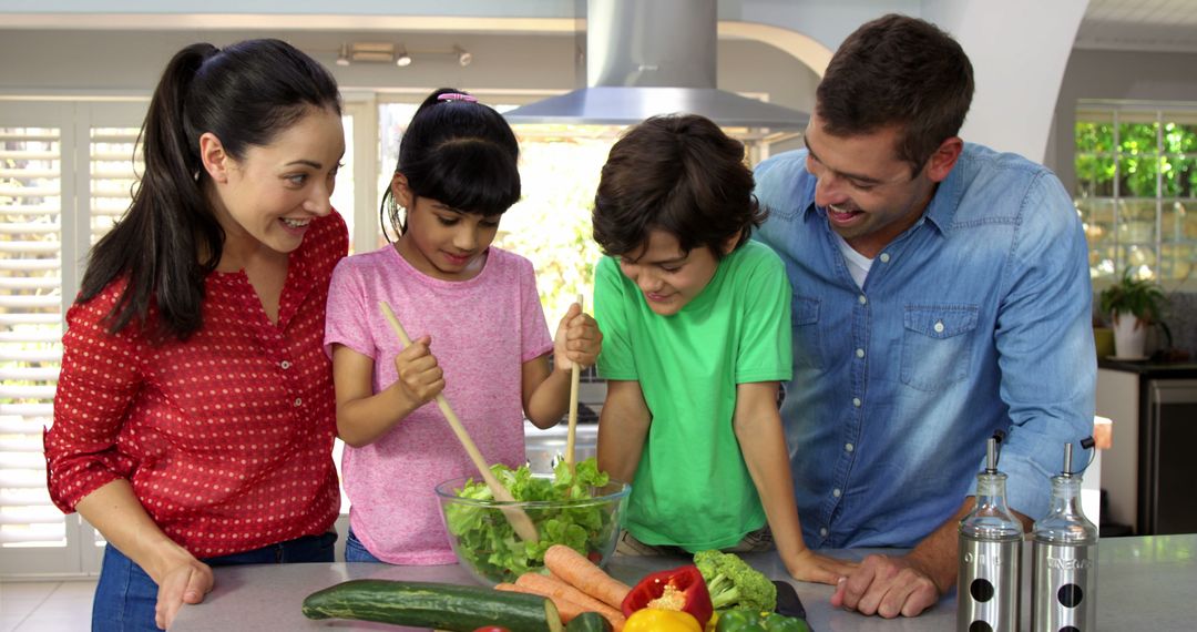 Smiling Family Preparing Healthy Salad Together in Modern Kitchen - Free Images, Stock Photos and Pictures on Pikwizard.com