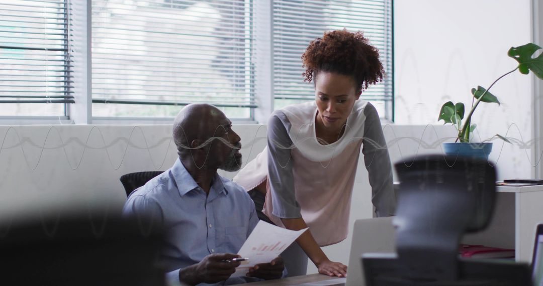 Professional Collaboration on Report in Modern Office Setting
