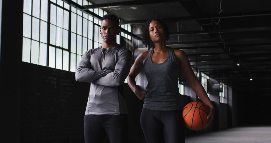 Athletic African American Man and Woman in Gym Holding Basketball - Free Images, Stock Photos and Pictures on Pikwizard.com