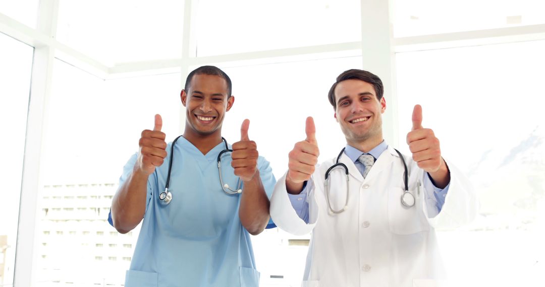 Smiling Medical Professionals Giving Thumbs Up in Bright Clinic Setting - Free Images, Stock Photos and Pictures on Pikwizard.com