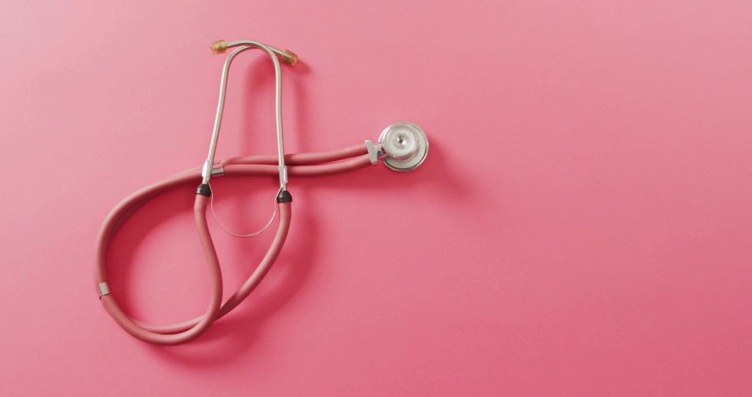 Pink Stethoscope Coiling on Monochrome Pink Background for Medical Branding and Wellness