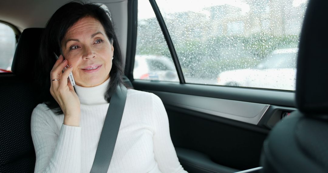 Mature Woman Talking On Phone In Car On Rainy Day - Free Images, Stock Photos and Pictures on Pikwizard.com