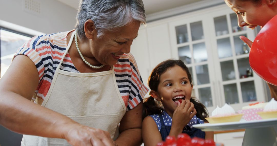 Happy Grandmother and Granddaughter Baking Together in Kitchen - Free Images, Stock Photos and Pictures on Pikwizard.com