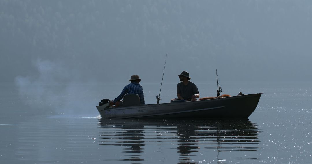 Two Men Fishing in Boat on Calm Mystical Lake at Sunrise - Free Images, Stock Photos and Pictures on Pikwizard.com