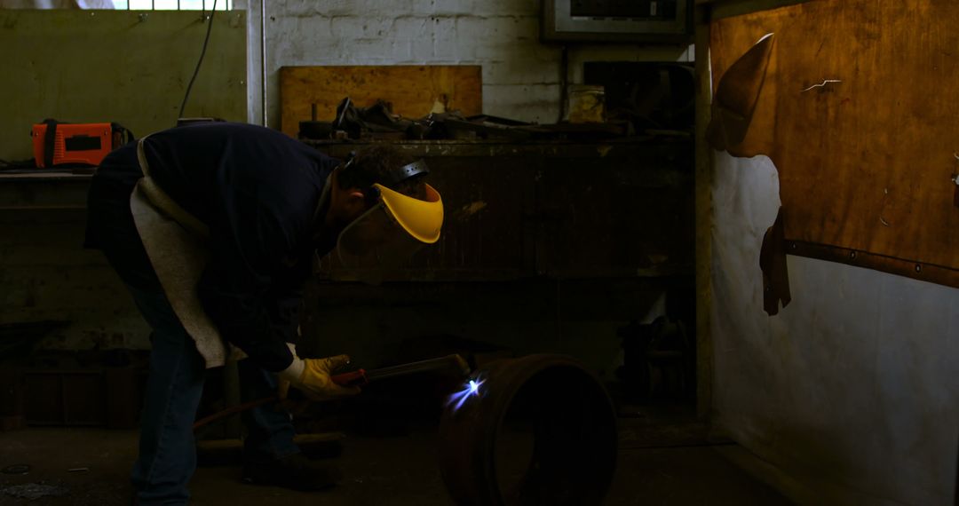 Man Welding Metal Tube in Workshop - Free Images, Stock Photos and Pictures on Pikwizard.com