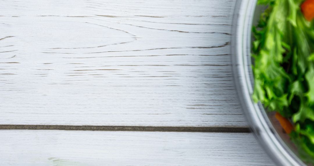 Fresh Vegetable Salad in Glass Bowl on Rustic Wooden Surface