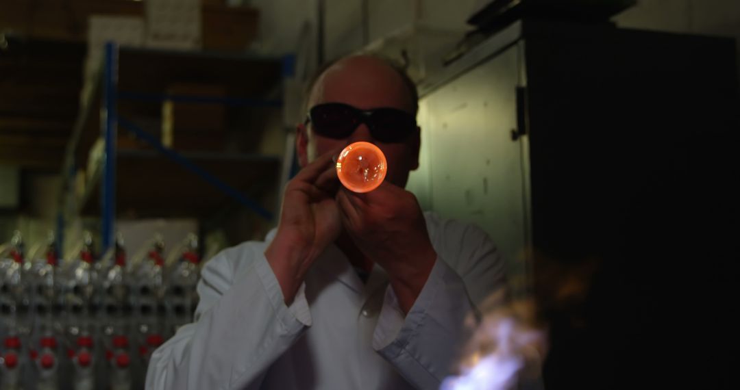 Glassblower Wearing Protective Gear Shaping Molten Glass - Free Images, Stock Photos and Pictures on Pikwizard.com