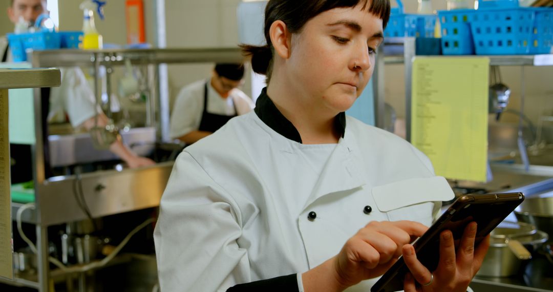 Chef Using Tablet in Commercial Kitchen - Free Images, Stock Photos and Pictures on Pikwizard.com