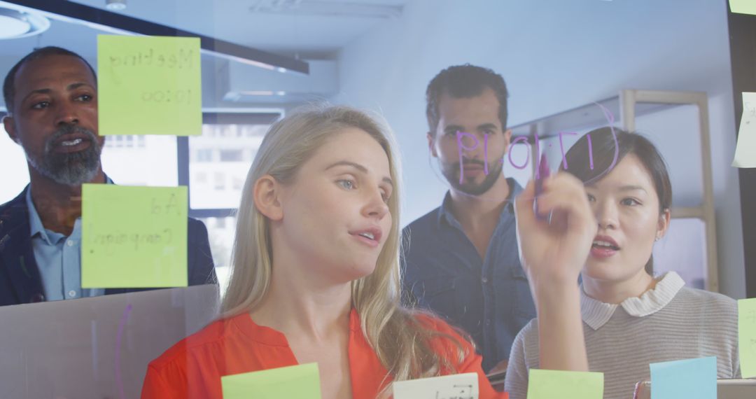 Business Team Brainstorming with Sticky Notes on Glass Wall - Free Images, Stock Photos and Pictures on Pikwizard.com