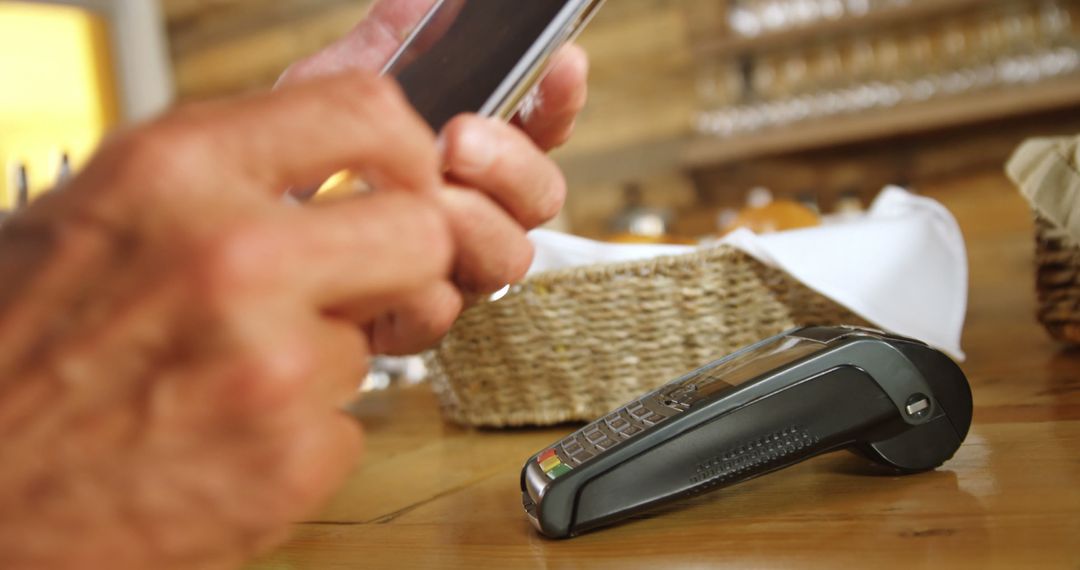 Person Making Mobile Payment in Café - Free Images, Stock Photos and Pictures on Pikwizard.com