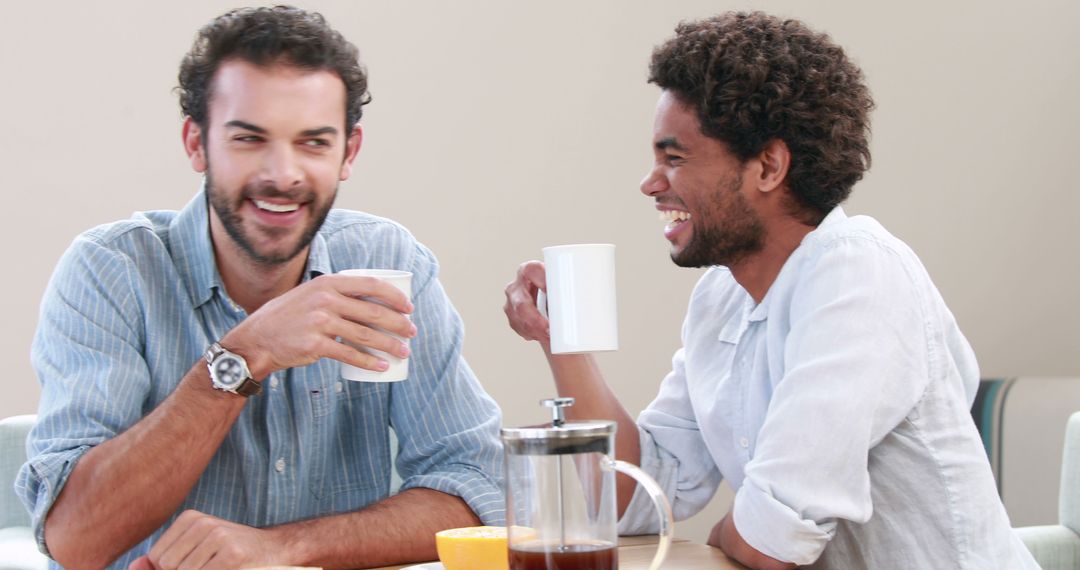 Friends Enjoying Coffee and Laughing at Cafe - Free Images, Stock Photos and Pictures on Pikwizard.com