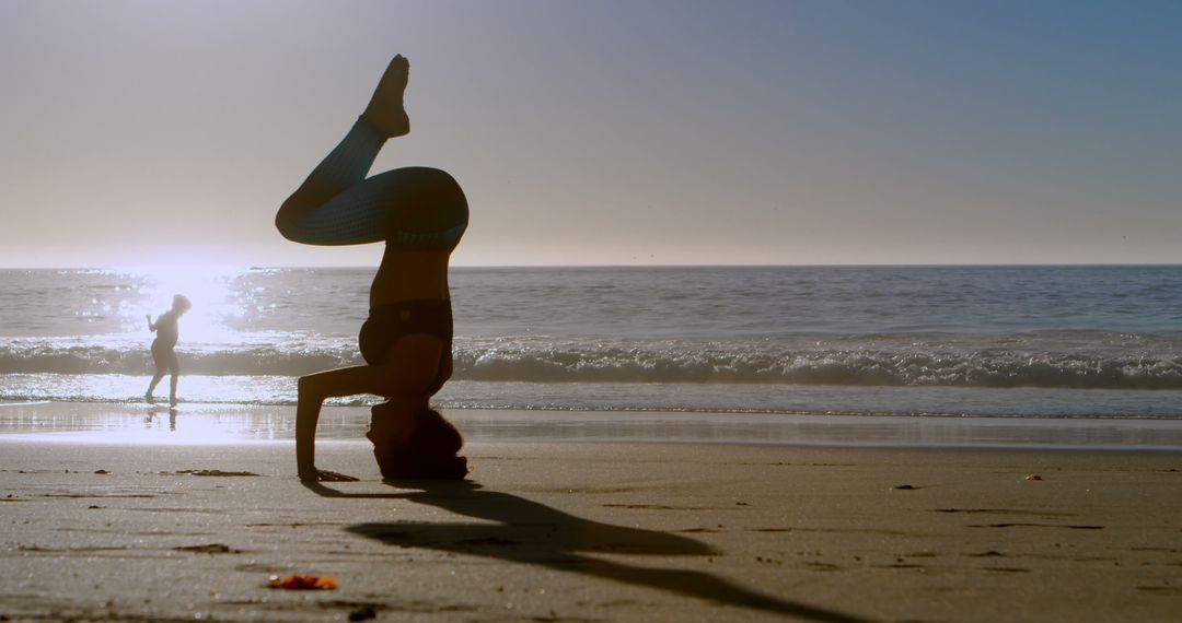 Person Performing Yoga Headstand on Beach at Sunset - Free Images, Stock Photos and Pictures on Pikwizard.com