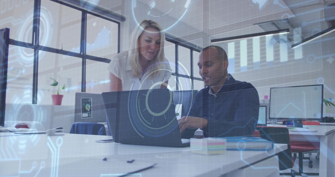Collaborating team using laptop with futuristic HUD overlay in modern open-plan office