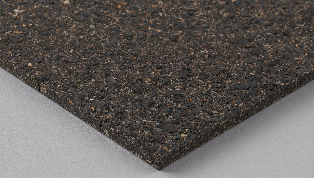 Dark recycled rubber composite slab with speckled granular texture and beveled edge