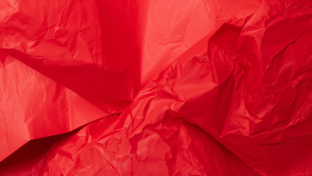 Crinkled Red Paper Texture Filling Frame with Deep Folds, Creases and Glossy Highlights
