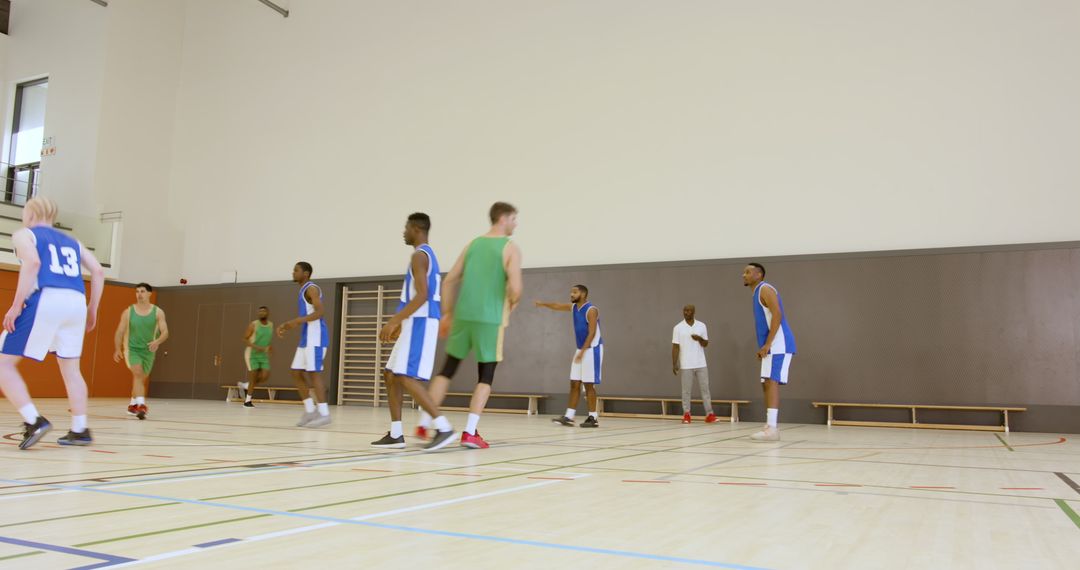 Intense Basketball Scrimmage Action in Indoor Gym