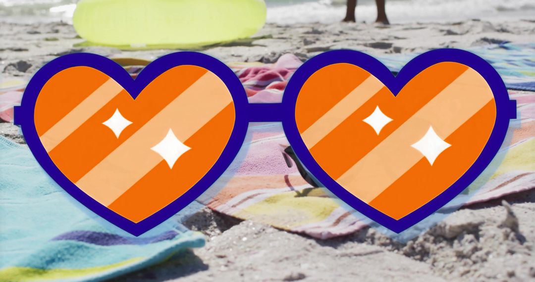 Vibrant Heart-Shaped Sunglasses on Beach Towels at Coastline