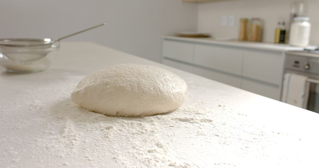 Fresh Dough Rising on Floured Countertop in Modern Kitchen