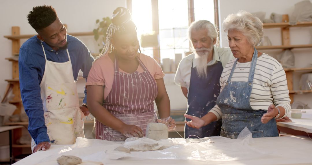 Group of Diverse Artists Sculpting Clay Together in a Studio - Free Images, Stock Photos and Pictures on Pikwizard.com