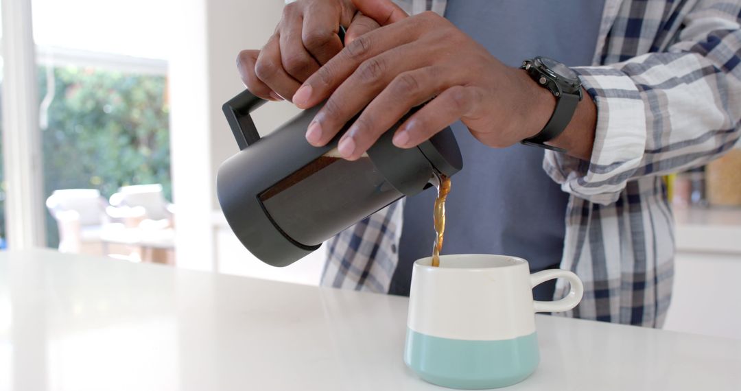 Person Pouring Freshly Brewed Coffee from French Press into Ceramic Mug - Free Images, Stock Photos and Pictures on Pikwizard.com