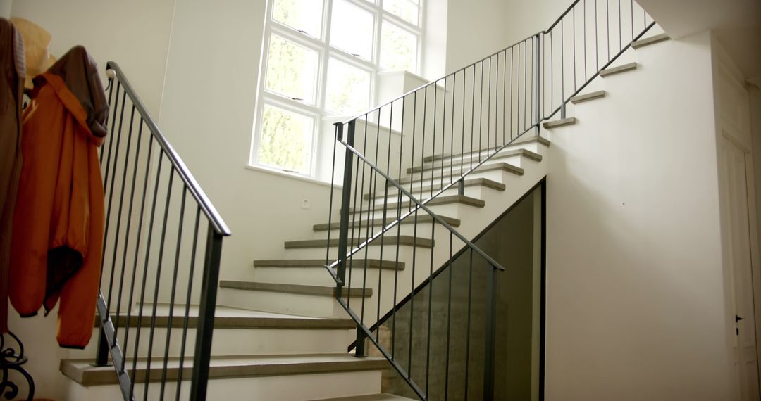 Modern Indoor Staircase with Iron Railings and Coat Rack - Free Images, Stock Photos and Pictures on Pikwizard.com