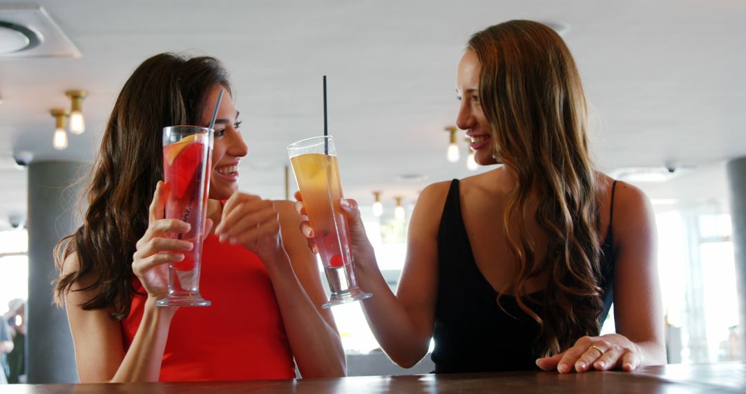 Two Women Enjoying Refreshing Drinks at Trendy Cafe - Free Images, Stock Photos and Pictures on Pikwizard.com