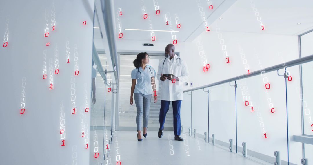 Medical professionals walking corridor using digital tablet with floating binary visuals