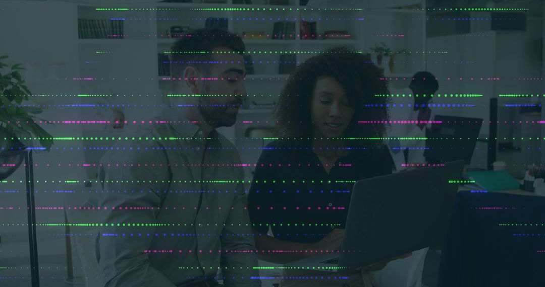 Collaborating Coworkers Using Laptop in Modern Office