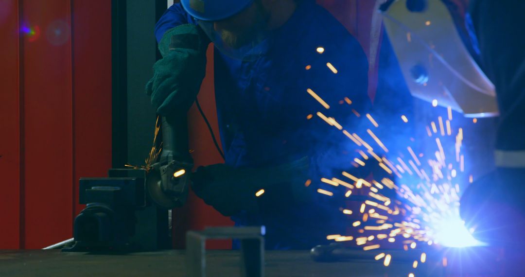 Engineers Welding in Industrial Warehouse with Sparks Flying - Free Images, Stock Photos and Pictures on Pikwizard.com