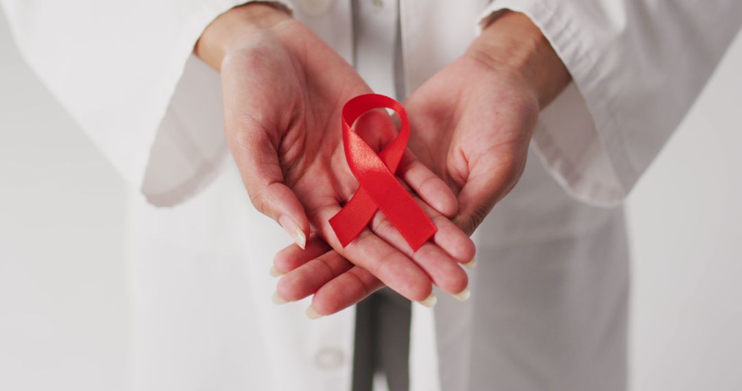 Image of biracial female doctor holding orange kidney cancer ribbon - Free Images, Stock Photos and Pictures on Pikwizard.com