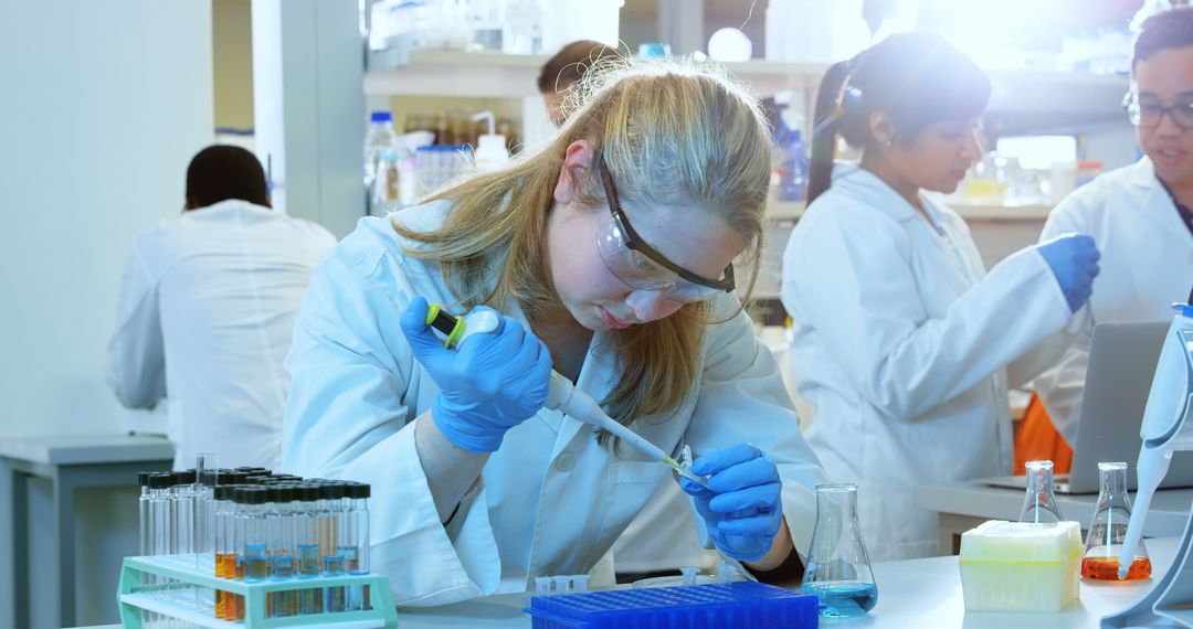 Scientist Conducting Research in Laboratory with Colleagues - Free Images, Stock Photos and Pictures on Pikwizard.com