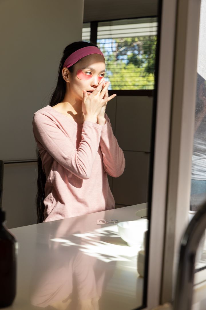 Woman with Under-Eye Gel Patches Practicing Skincare Routine